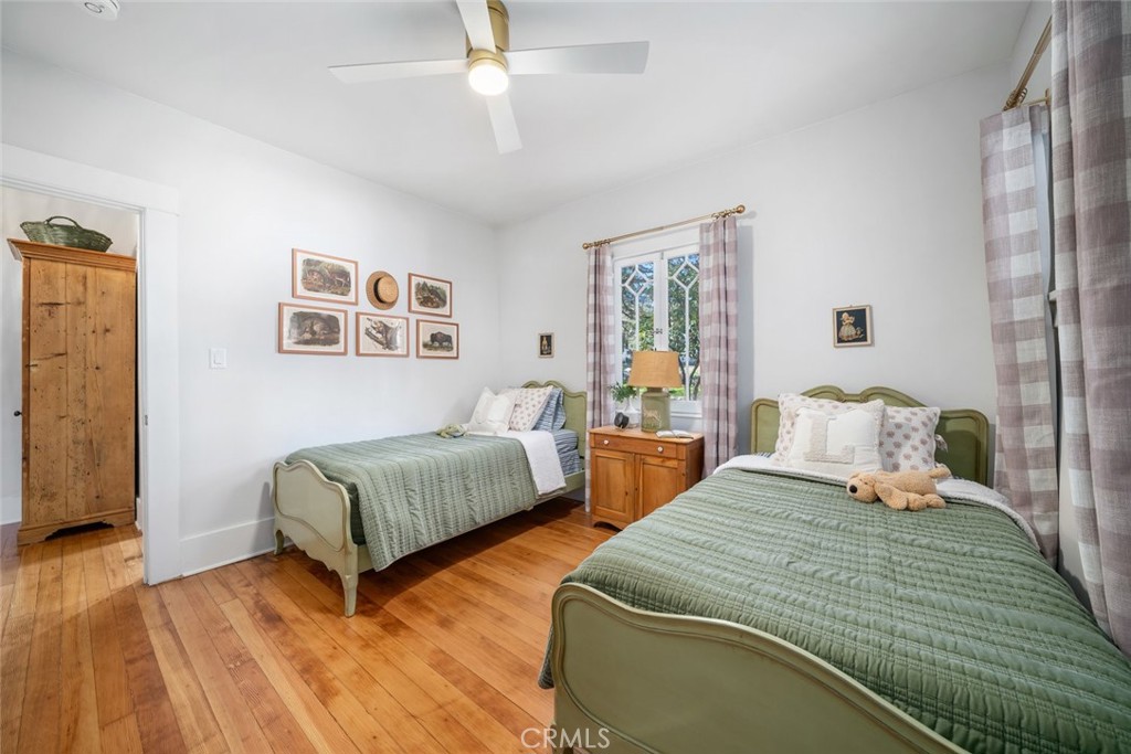 135 18th Street Paso Robles, CA 93446 - Photo 19 of 45 a bedroom with two beds and a chandelier
