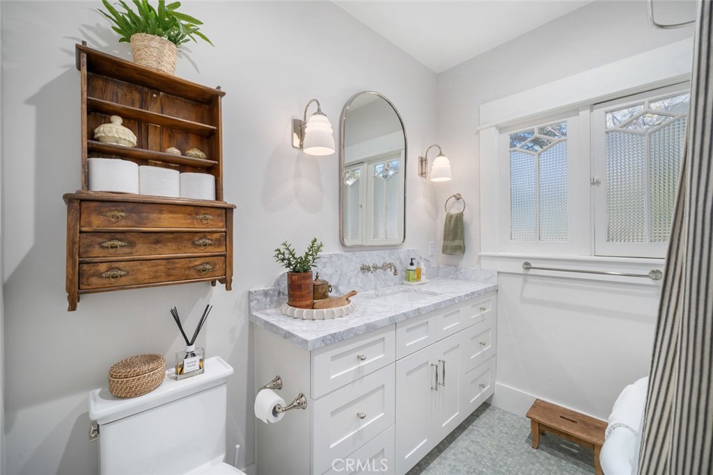 135 18th Street Paso Robles, CA 93446 - Photo 21 of 45 a bathroom with a sink a toilet and a mirror