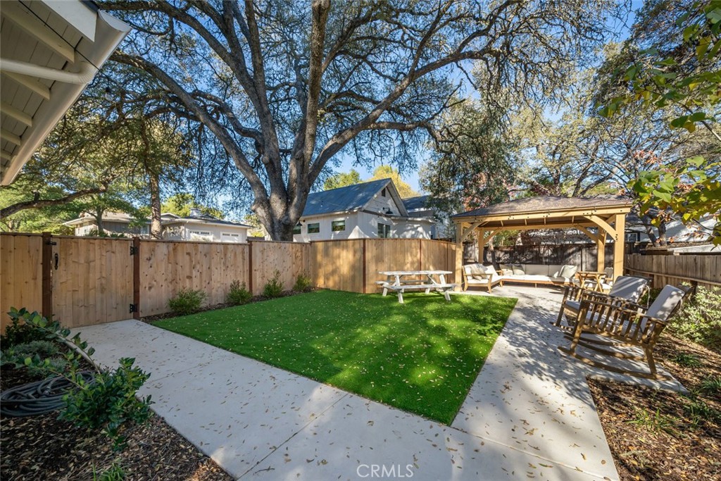 135 18th Street Paso Robles, CA 93446 - Photo 26 of 45 a view of backyard with table and chairs and potted plants