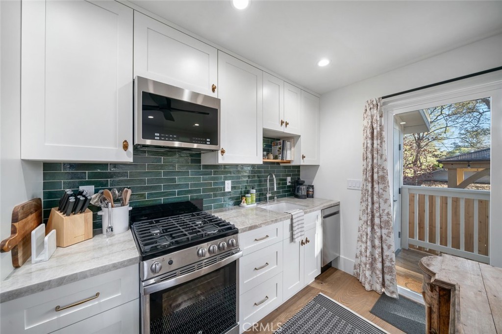 135 18th Street Paso Robles, CA 93446 - Photo 38 of 45 a kitchen with stainless steel appliances granite countertop a stove a sink and a microwave