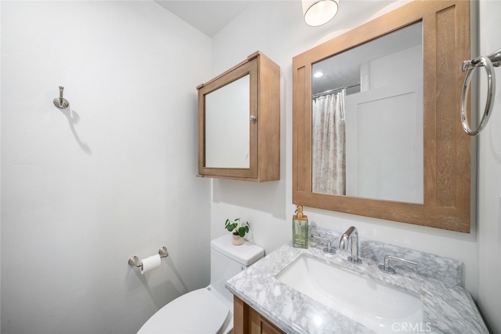 135 18th Street Paso Robles, CA 93446 - Photo 39 of 45 a bathroom with a granite countertop sink mirror and a toilet
