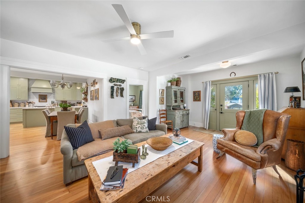 135 18th Street Paso Robles, CA 93446 - Photo 5 of 45 a living room with furniture or couches and a dining table with wooden floor
