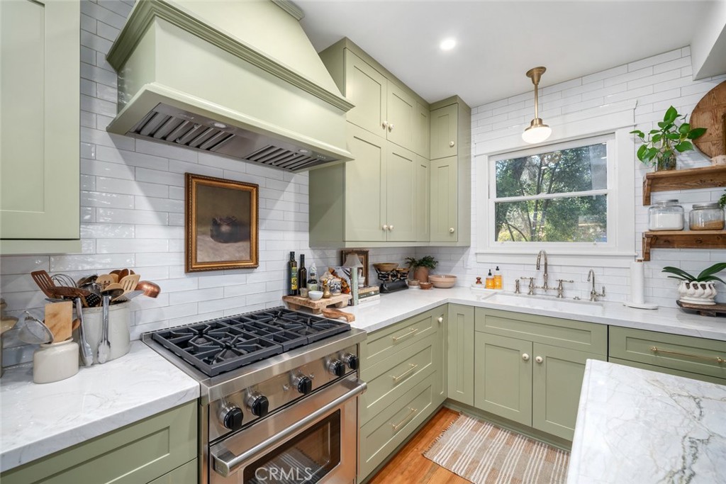 135 18th Street Paso Robles, CA 93446 - Photo 9 of 45 a kitchen with a sink a stove cabinets and a window