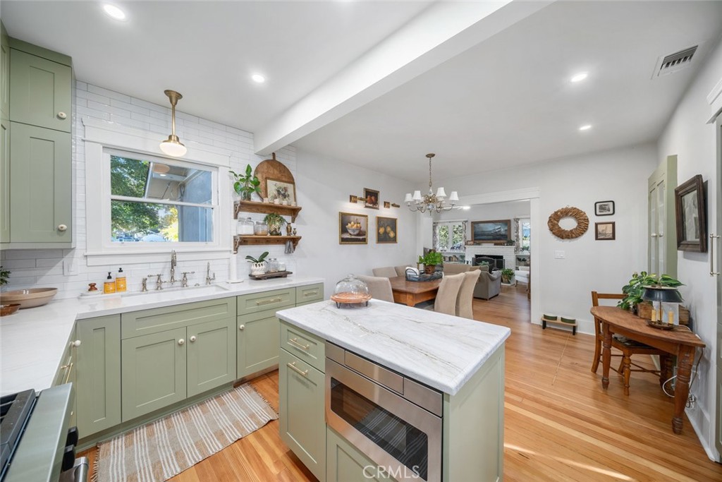 135 18th Street Paso Robles, CA 93446 - Photo 10 of 45 a open kitchen with stainless steel appliances granite countertop a stove top oven a sink dishwasher and white cabinets with wooden floor