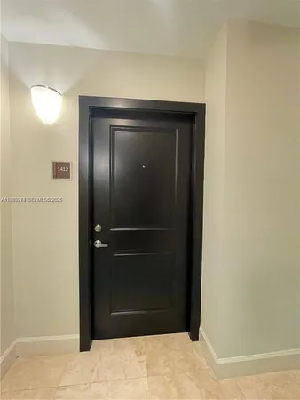 a room with a wooden door and mirror