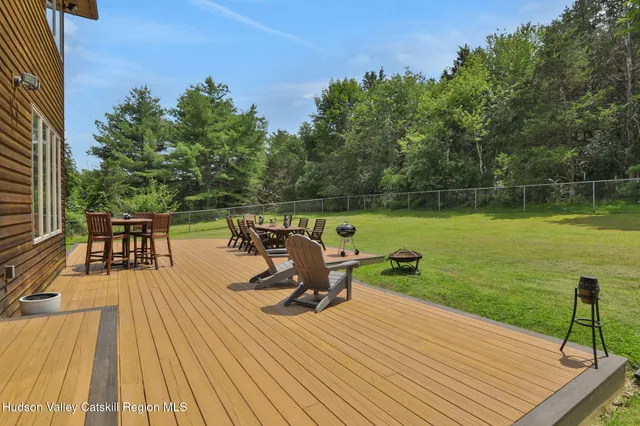 a backyard of a house with a yard and large tree