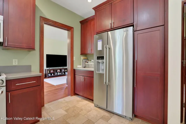 a kitchen with stainless steel appliances granite countertop a refrigerator and a stove top oven