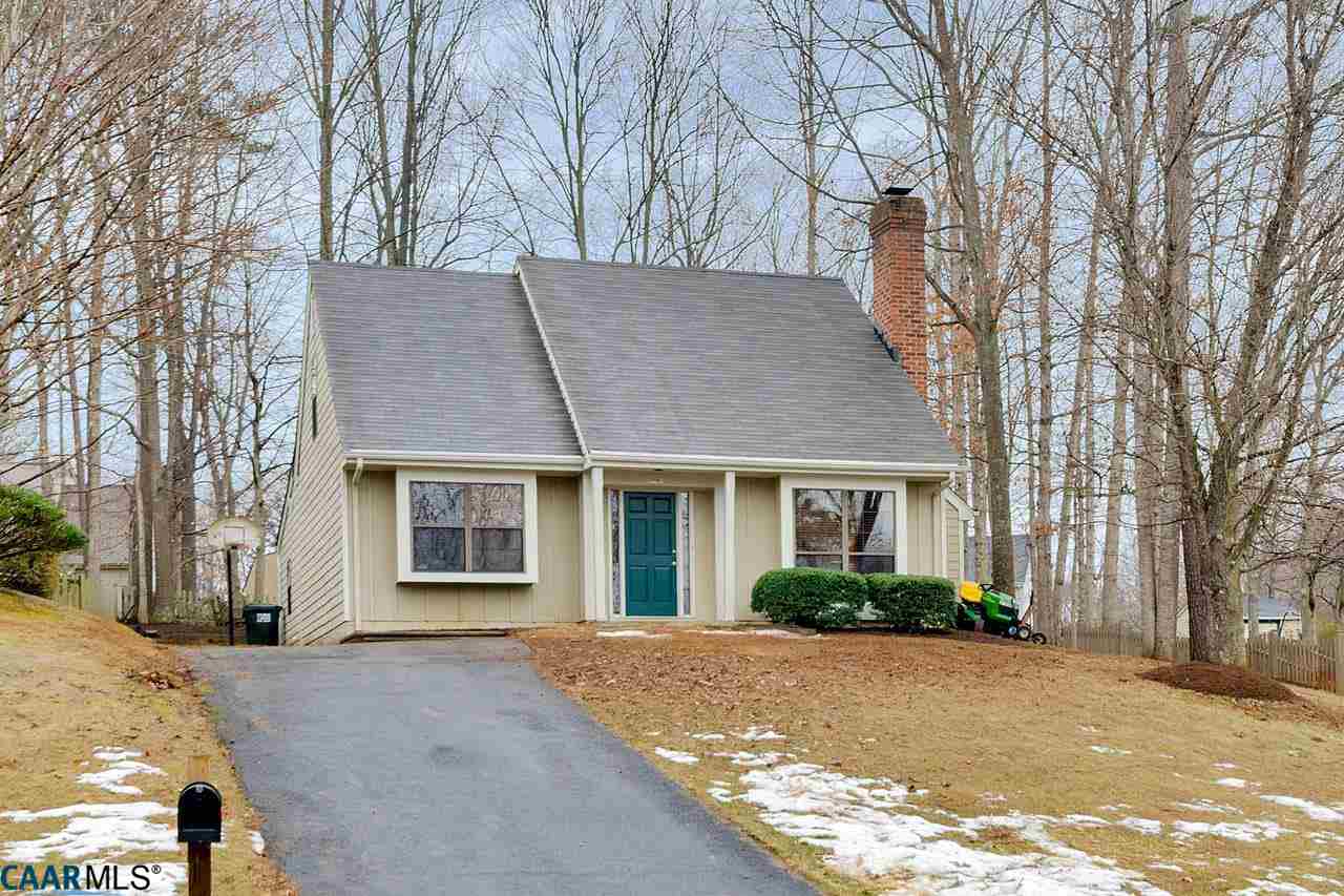 a front view of house with yard and trees