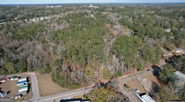 an aerial view of a forest with houses