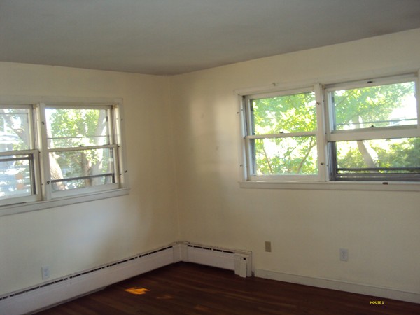 8 Rosemont Road Worcester, MA 01605 - Photo 14 of 30 an empty room with wooden floor and windows