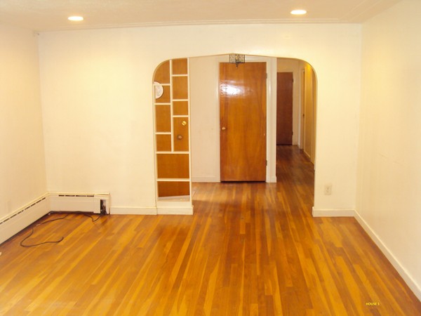 8 Rosemont Road Worcester, MA 01605 - Photo 10 of 30 a view of an empty room with wooden floor and a window