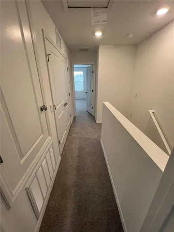 a view of a hallway with staircase