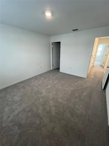 an empty room with window and mirror