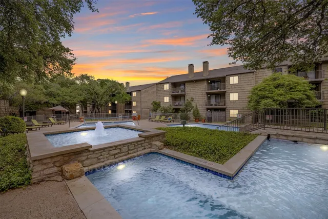 a view of a swimming pool with an outdoor seating