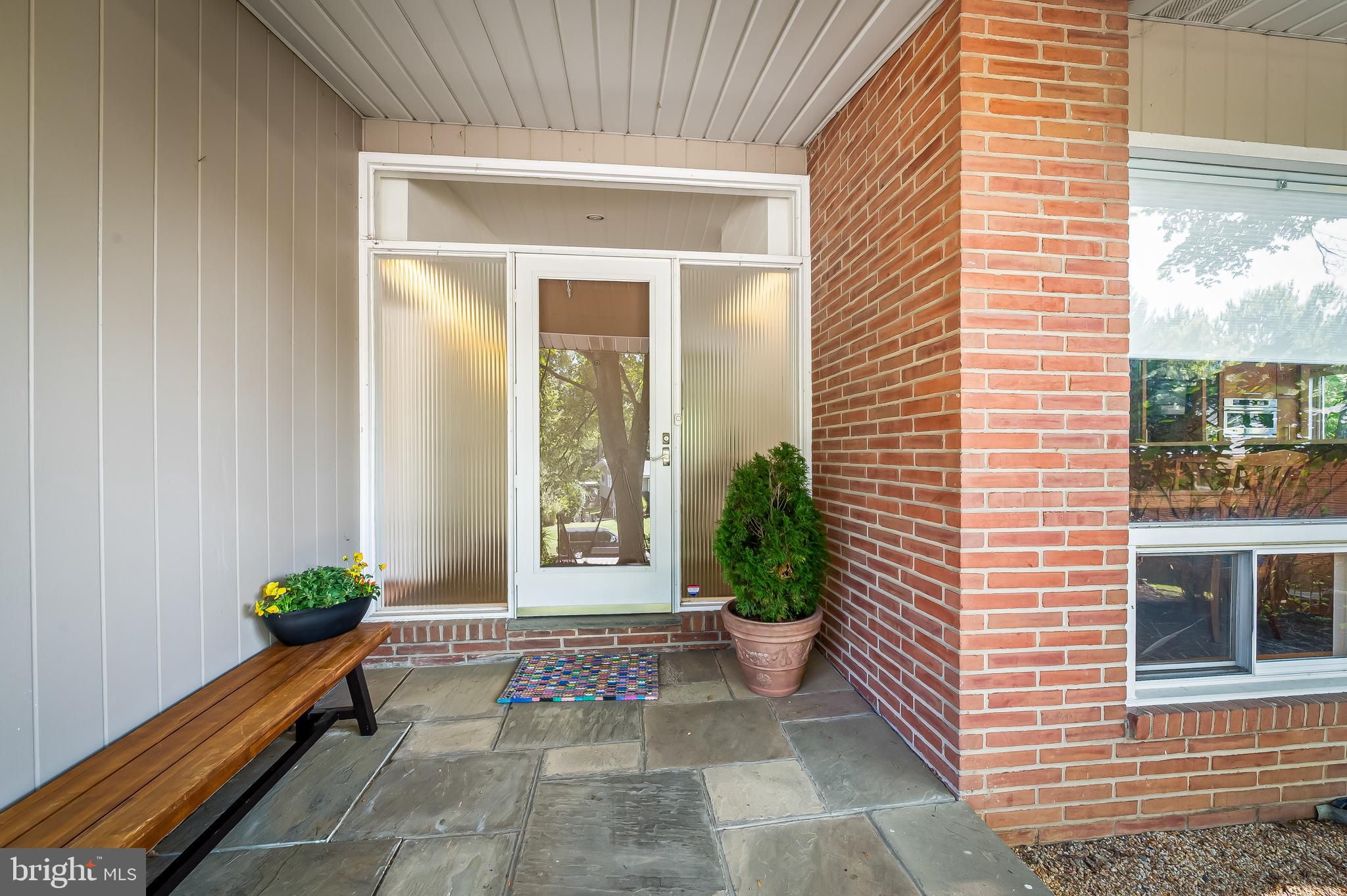 6103 Ivydene Terrace Baltimore, MD 21209 - Photo 1 of 51 a house with potted plants in front of door