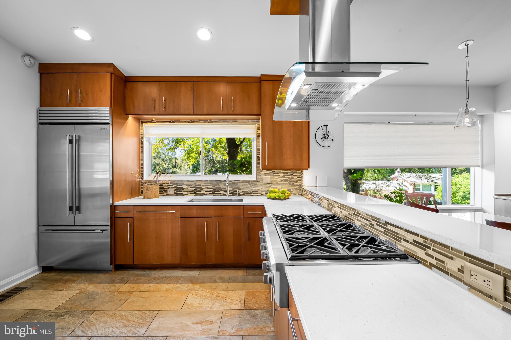 6103 Ivydene Terrace Baltimore, MD 21209 - Photo 11 of 51 a kitchen with stainless steel appliances granite countertop a stove and a refrigerator