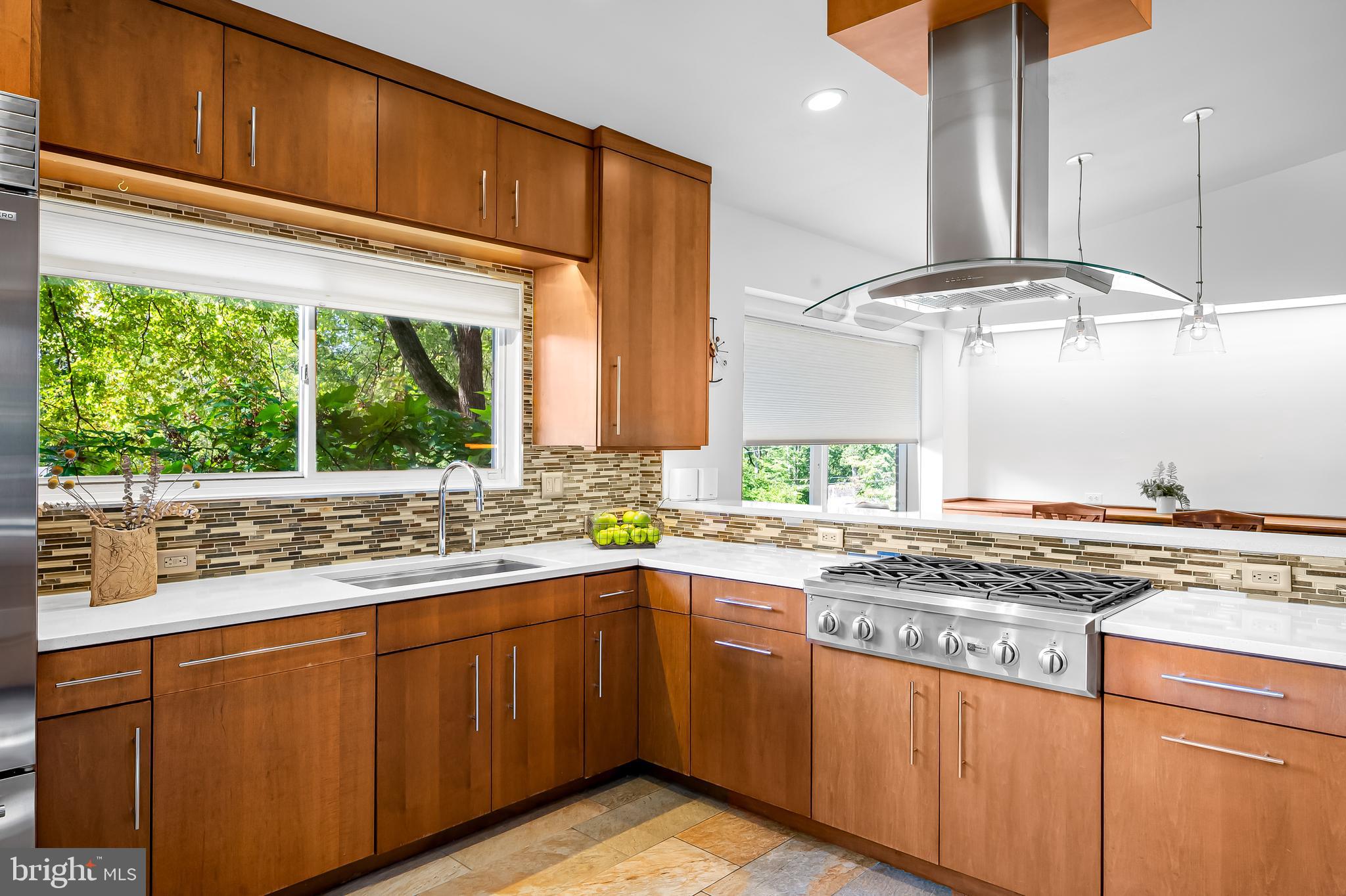 6103 Ivydene Terrace Baltimore, MD 21209 - Photo 13 of 51 a kitchen with kitchen island granite countertop a sink and a stove