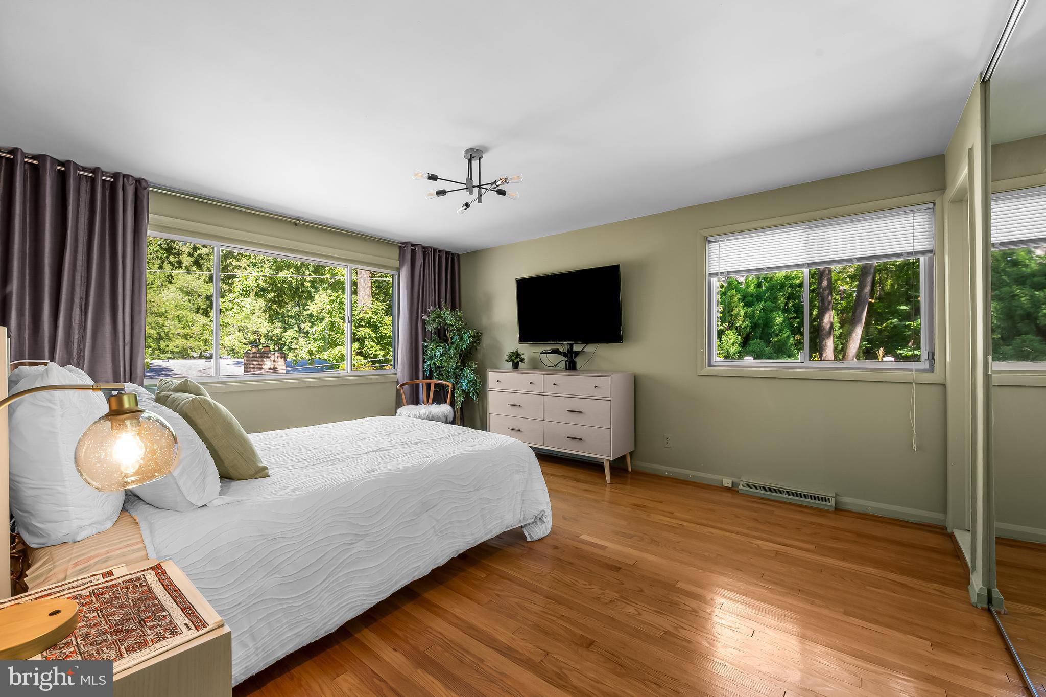 6103 Ivydene Terrace Baltimore, MD 21209 - Photo 32 of 51 a bedroom with a bed and a chandelier