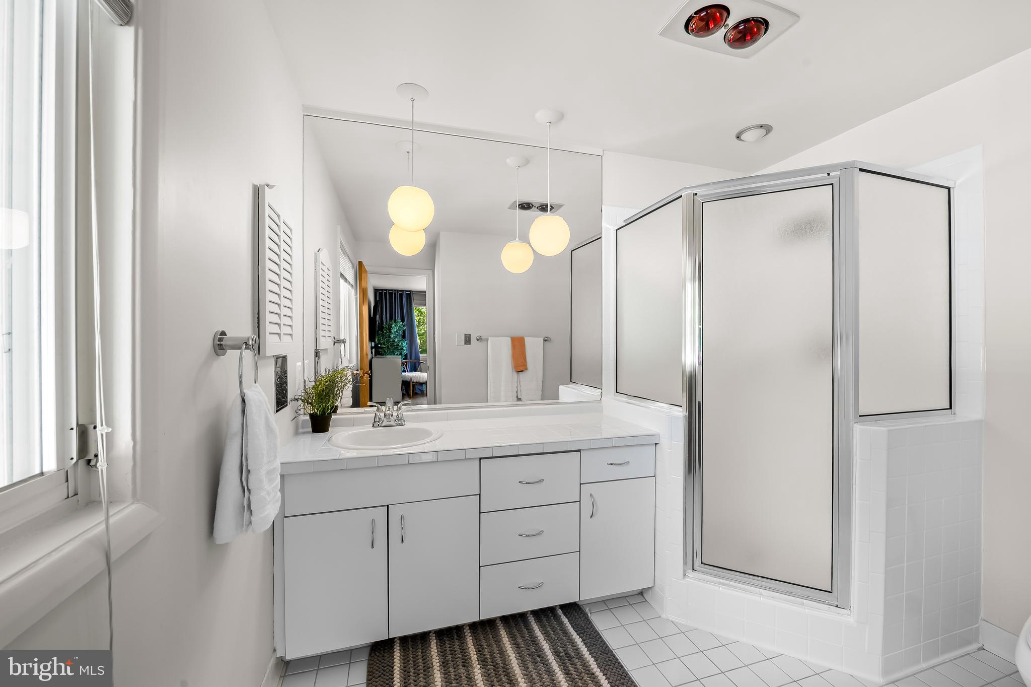6103 Ivydene Terrace Baltimore, MD 21209 - Photo 34 of 51 a spacious bathroom with a double vanity sink and a mirror