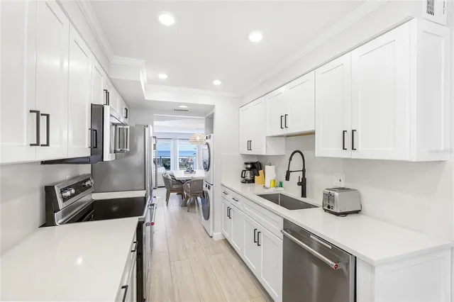 a kitchen with a sink a stove and cabinets