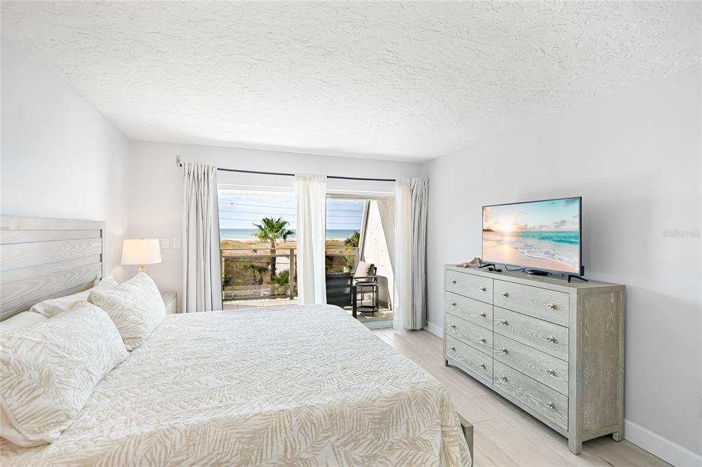 625 Beach Road, Unit 407 Sarasota, FL 34242 - Photo 15 of 43 a bedroom with a bed and a flat screen tv