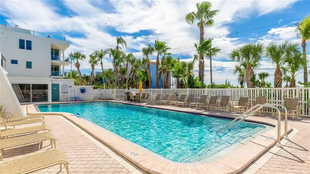 a view of a swimming pool with a patio and a garden