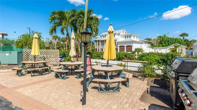 a backyard of a house with barbeque oven table and chairs