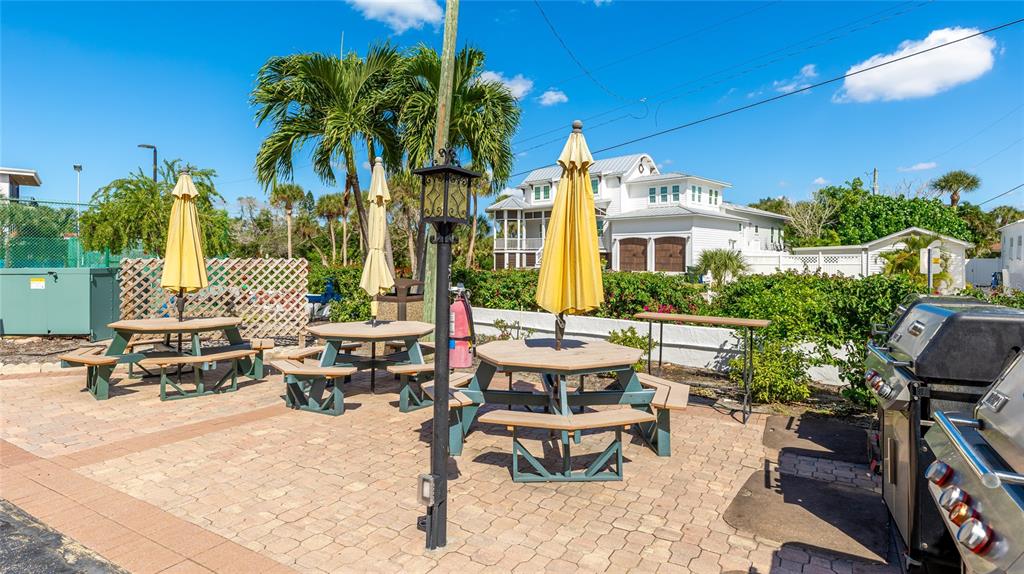 625 Beach Road, Unit 407 Sarasota, FL 34242 - Photo 34 of 43 a front view of a house with swimming pool and sitting area