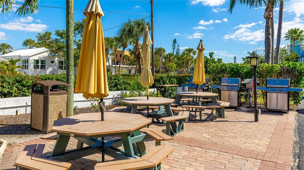 625 Beach Road, Unit 407 Sarasota, FL 34242 - Photo 35 of 43 a backyard of a house with barbeque oven table and chairs