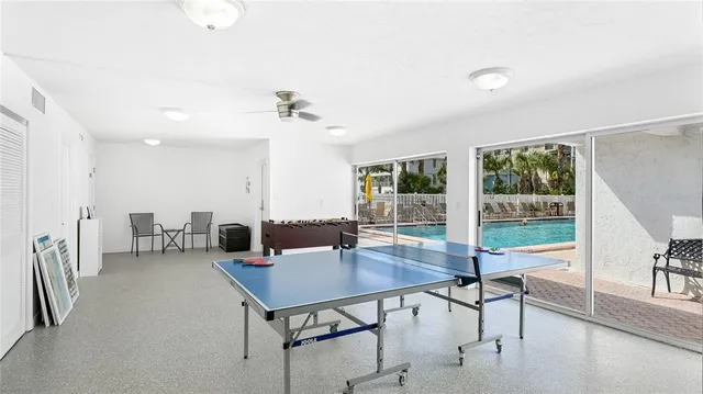 a living room with furniture and a book shelf