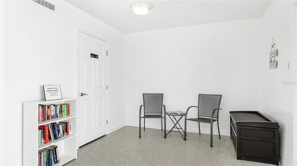 625 Beach Road, Unit 407 Sarasota, FL 34242 - Photo 43 of 43 a living room with furniture and a book shelf