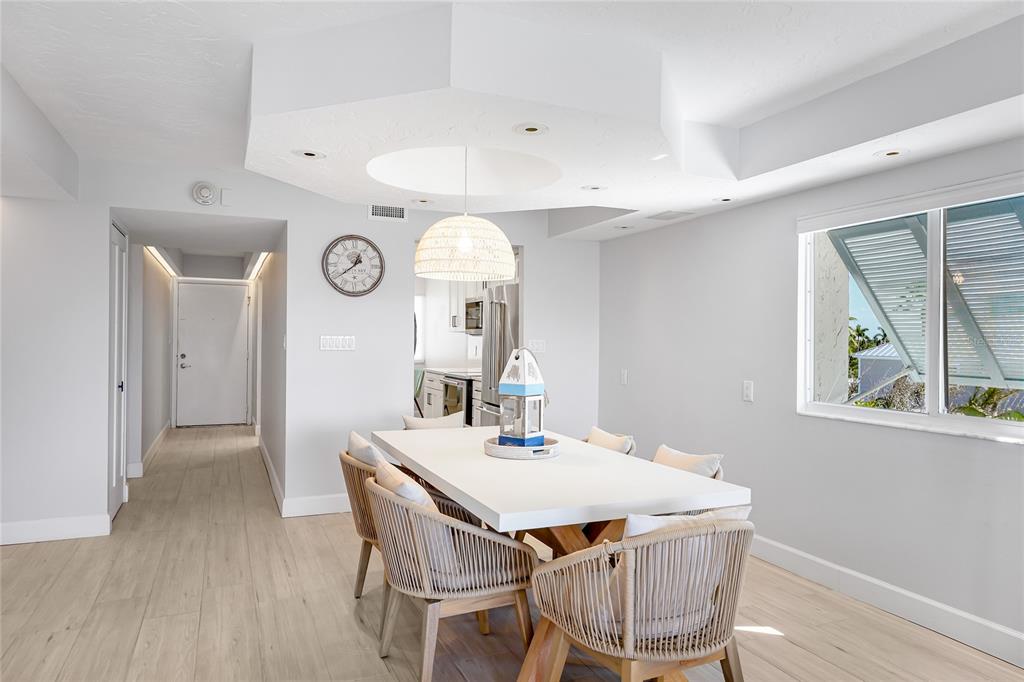 625 Beach Road, Unit 407 Sarasota, FL 34242 - Photo 5 of 43 a view of a dining room with furniture and wooden floor