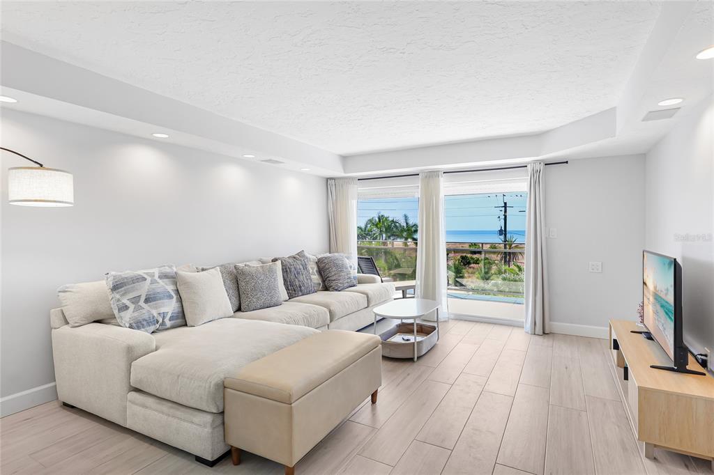 625 Beach Road, Unit 407 Sarasota, FL 34242 - Photo 6 of 43 a living room with furniture and a flat screen tv