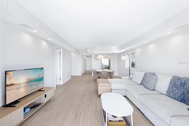 a living room with furniture flat screen tv and wooden floor