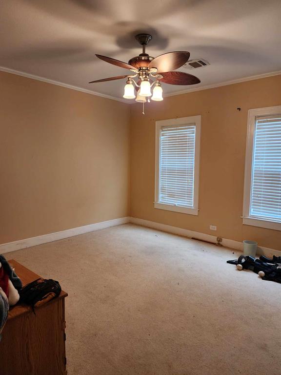 202 Pine Street Logansport, LA 71049 - Photo 14 of 19 Unfurnished room with ornamental molding, carpet floors, and ceiling fan