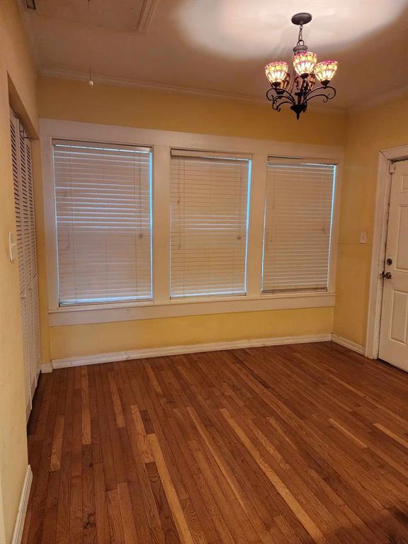 202 Pine Street Logansport, LA 71049 - Photo 18 of 19 Spare room with ornamental molding, hardwood / wood-style flooring, and a chandelier