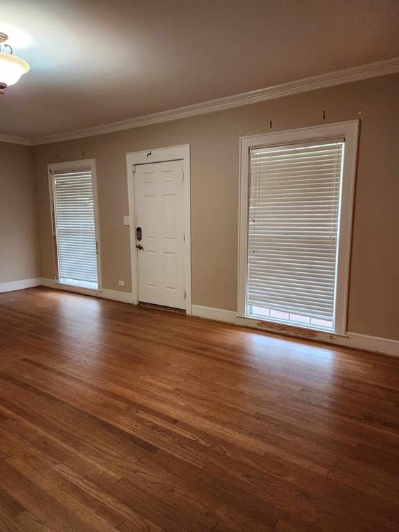 202 Pine Street Logansport, LA 71049 - Photo 8 of 19 Spare room featuring ornamental molding and hardwood / wood-style floors