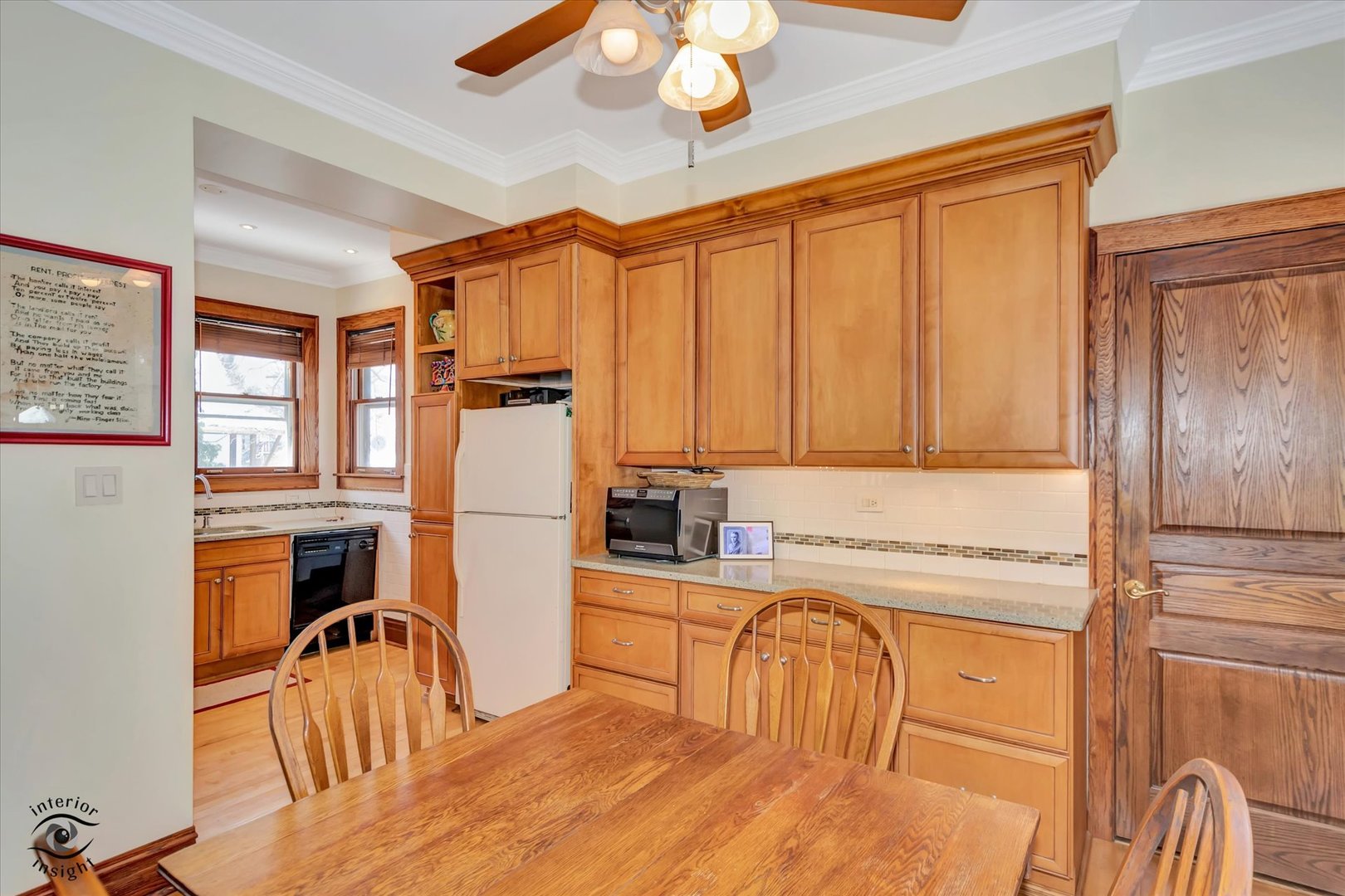 1650 West 105th Street Chicago, IL 60643 - Photo 18 of 43 a kitchen with stainless steel appliances granite countertop a refrigerator a stove a sink dishwasher a dining table and chairs with wooden floor