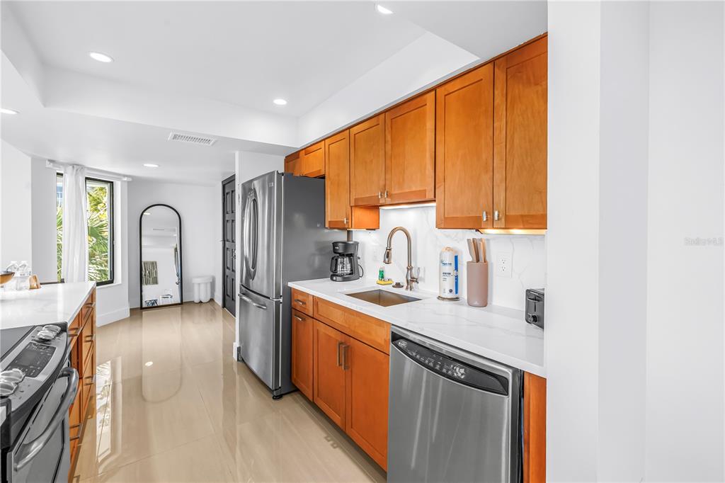 450 Beach Road, Unit 4 Sarasota, FL 34242 - Photo 14 of 64 a kitchen with sink cabinets and window