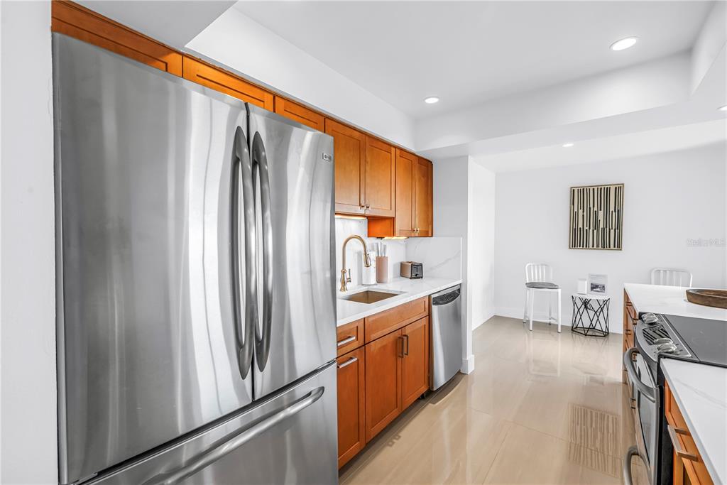 450 Beach Road, Unit 4 Sarasota, FL 34242 - Photo 16 of 64 a kitchen with stainless steel appliances a refrigerator and a stove top oven