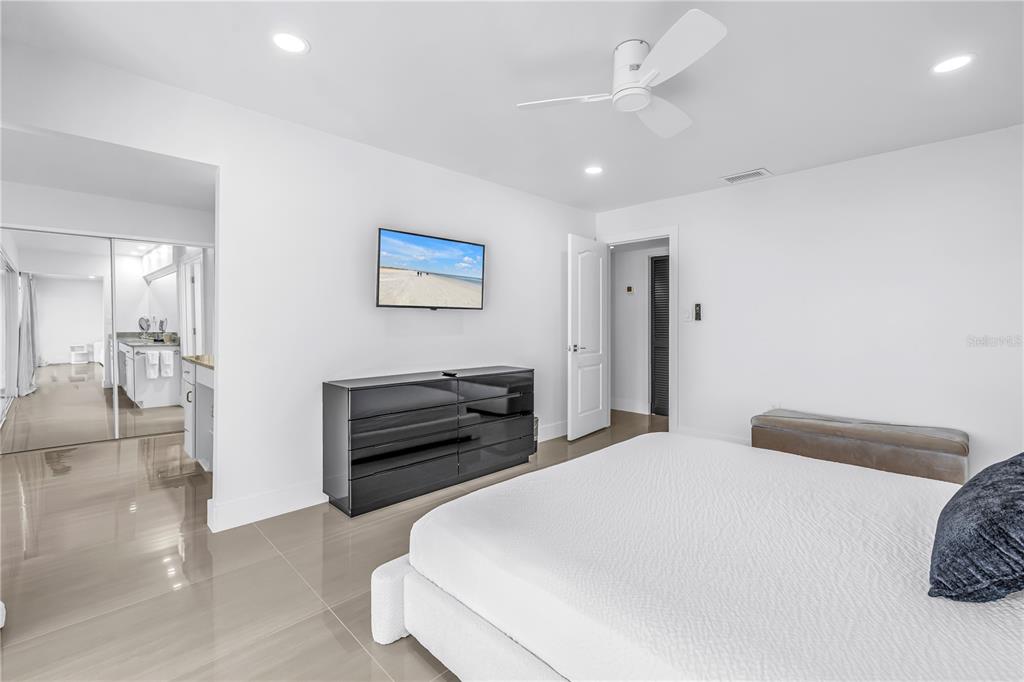 450 Beach Road, Unit 4 Sarasota, FL 34242 - Photo 27 of 64 a bedroom with a bed and a chandelier