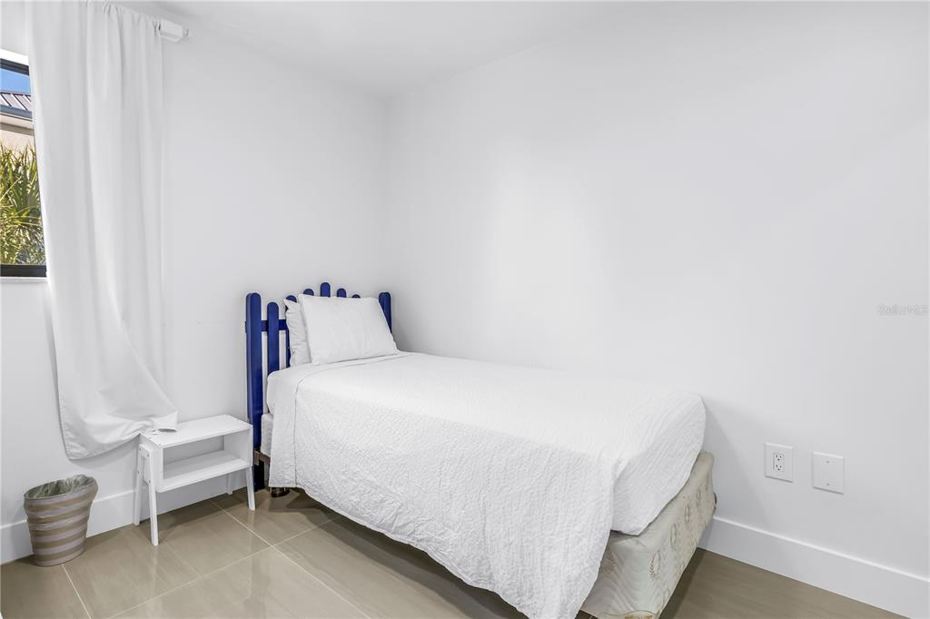 450 Beach Road, Unit 4 Sarasota, FL 34242 - Photo 33 of 64 a bedroom with a bed and a window