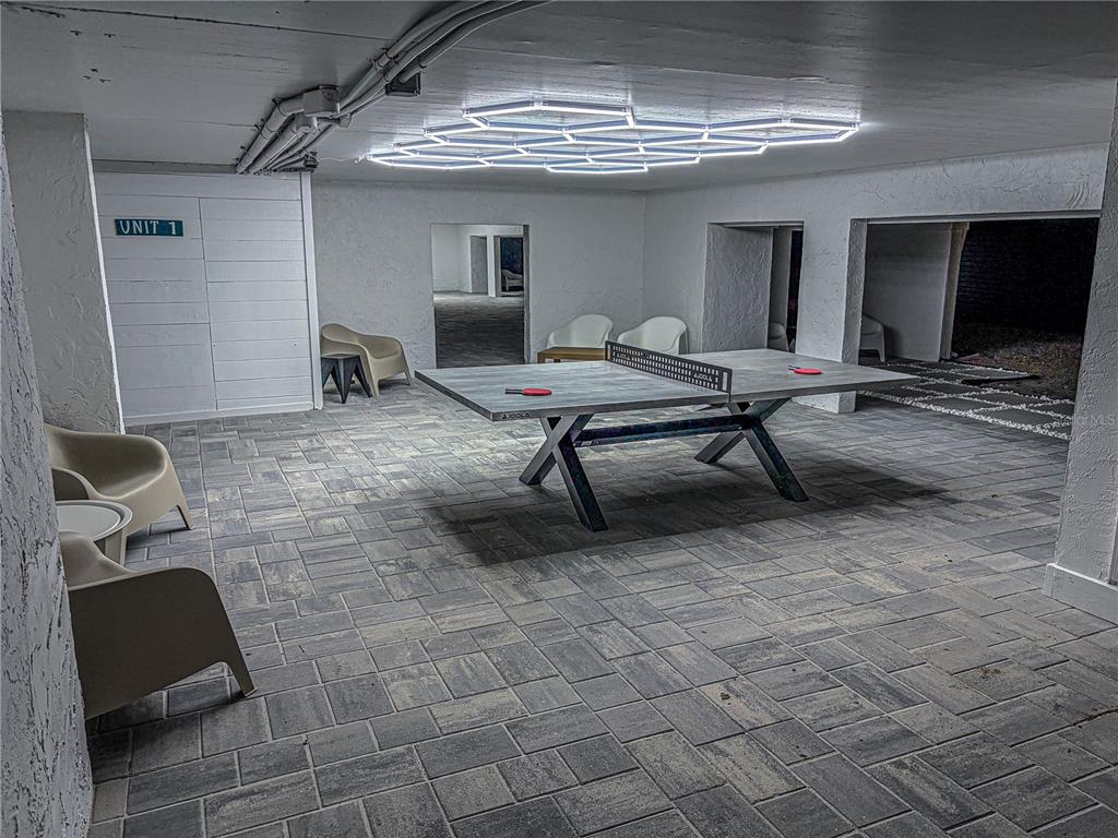 450 Beach Road, Unit 4 Sarasota, FL 34242 - Photo 53 of 64 a living room with a couch and a chandelier