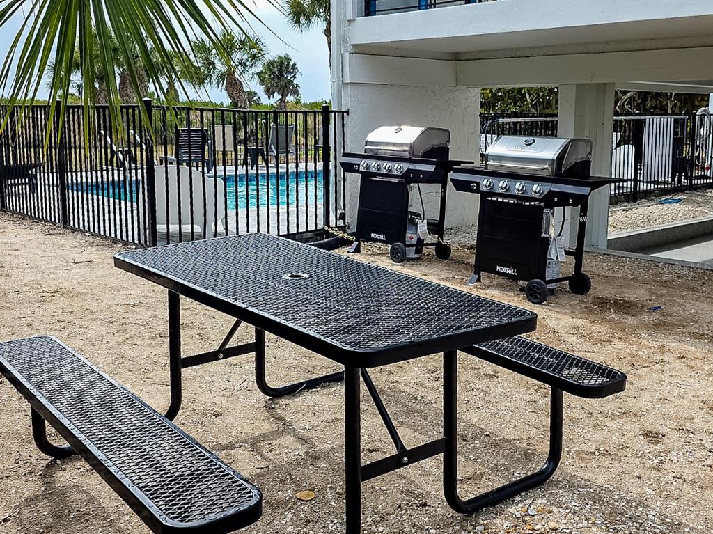 450 Beach Road, Unit 4 Sarasota, FL 34242 - Photo 56 of 64 a view of a dinning tables and chairs in the patio
