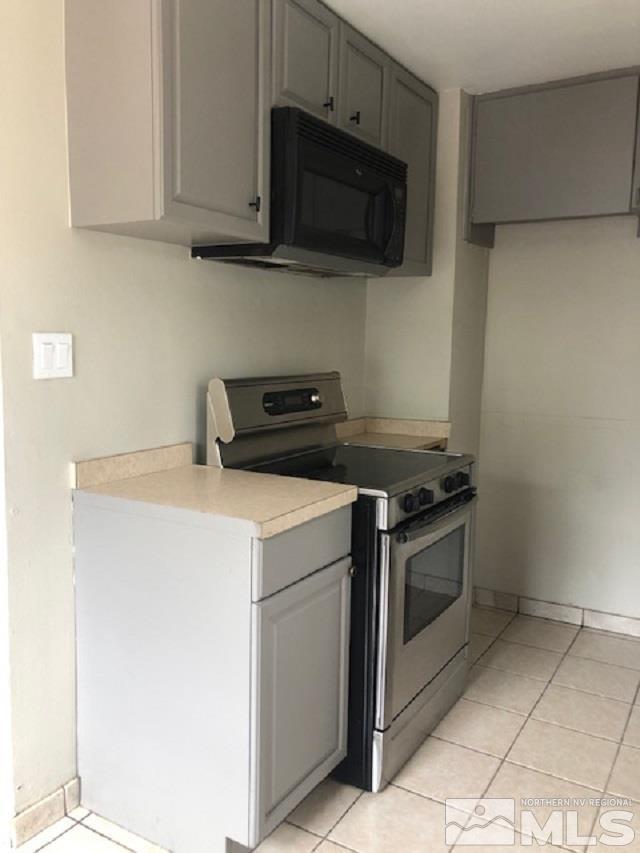 355 Gould Street Reno, NV 89502 - Photo 3 of 24 a kitchen with a stove and a microwave