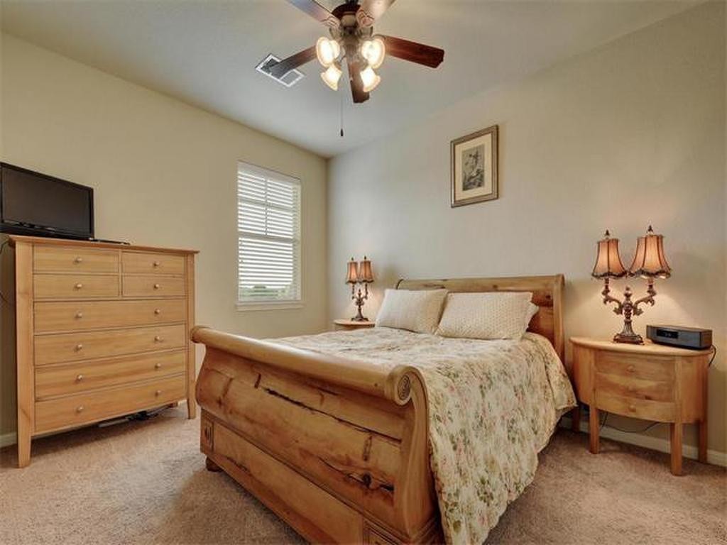 a bedroom with a bed and a dresser