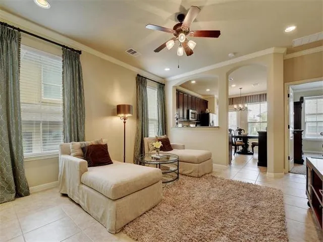 a living room with furniture and wooden floor