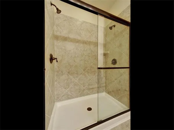 a bathroom with a glass shower door