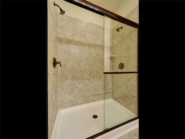 a bathroom with a glass shower door