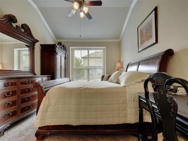 a bedroom with a bed and dresser with mirror